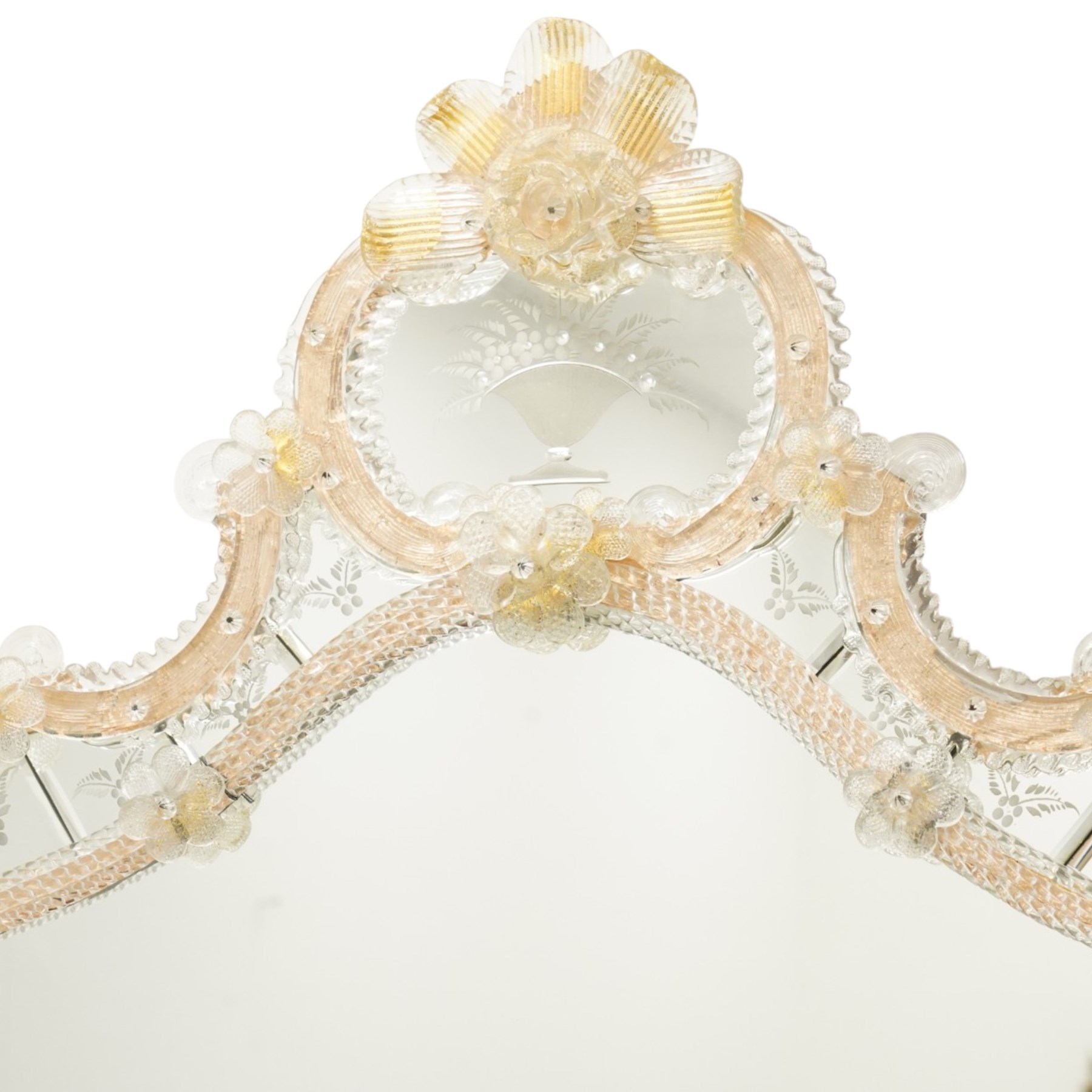 20th century Venetian glass wall mirror, the shaped plate within a mirrored frame applied with clear glass flowerheads and moulded glass edging, with etched floral decoration to the bevelled 'frameless' plates, the inner slip with ropetwist moulded glass