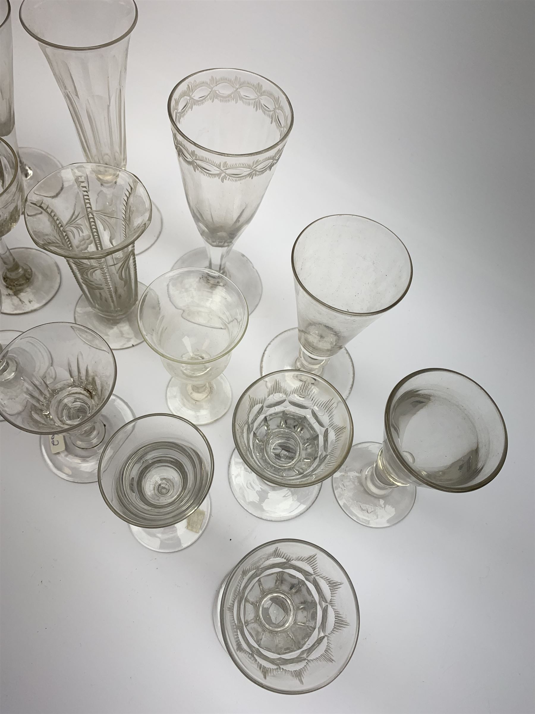 A group of early 19th century and later drinking glasses, to include two toastmaster type examples with deceptive bowls, together with a Bonnet glass or monteith, probably late 18th century. 