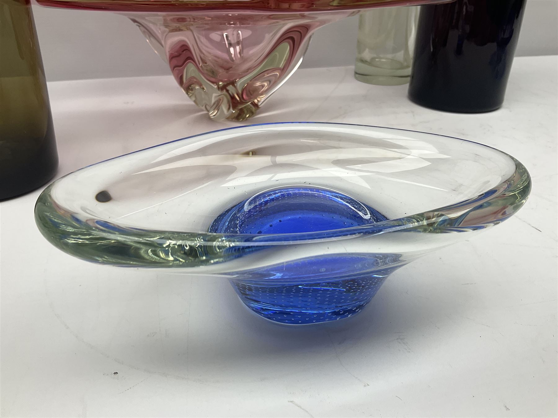 Two Whitefriars glass jugs, together with a Swedish Pukeberg art glass vase and three art glass bowls, including large pink example, some signed to base, tallest H30.5cm