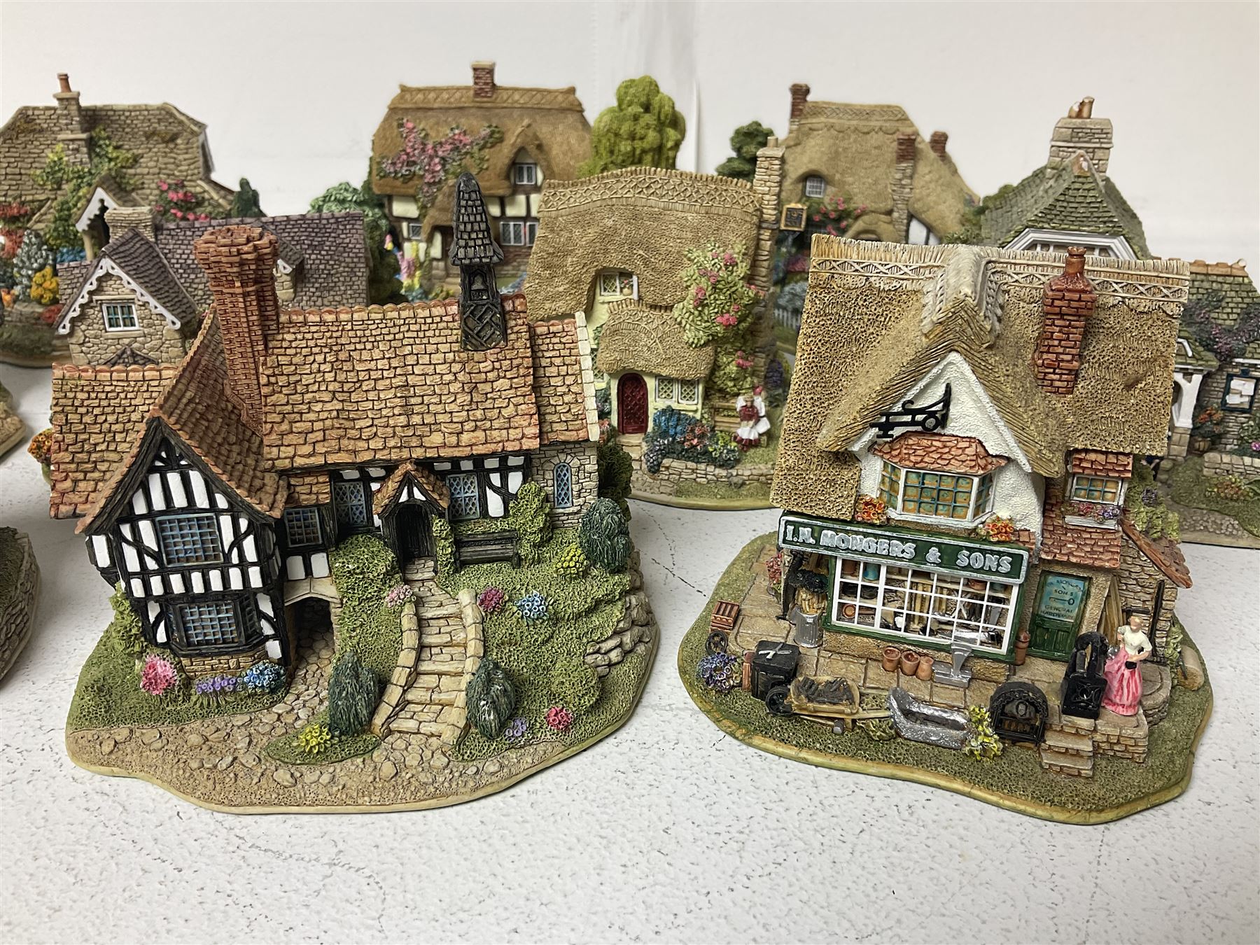 Fifteen Lilliput Lane models, including The Nineteenth Hole, Cowslip Cottage, The Lion Mongers, Going For a Song and Old Crofty, Gossip Gate and Beehive Cottage, all with deeds and original boxes (15)