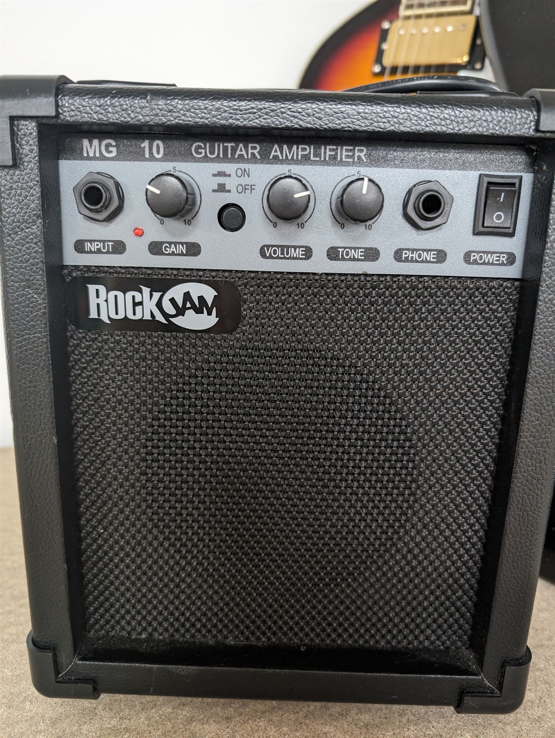 Rock Jam six string electric guitar, together with a Rock Jam amplifier and an Atrics guitar