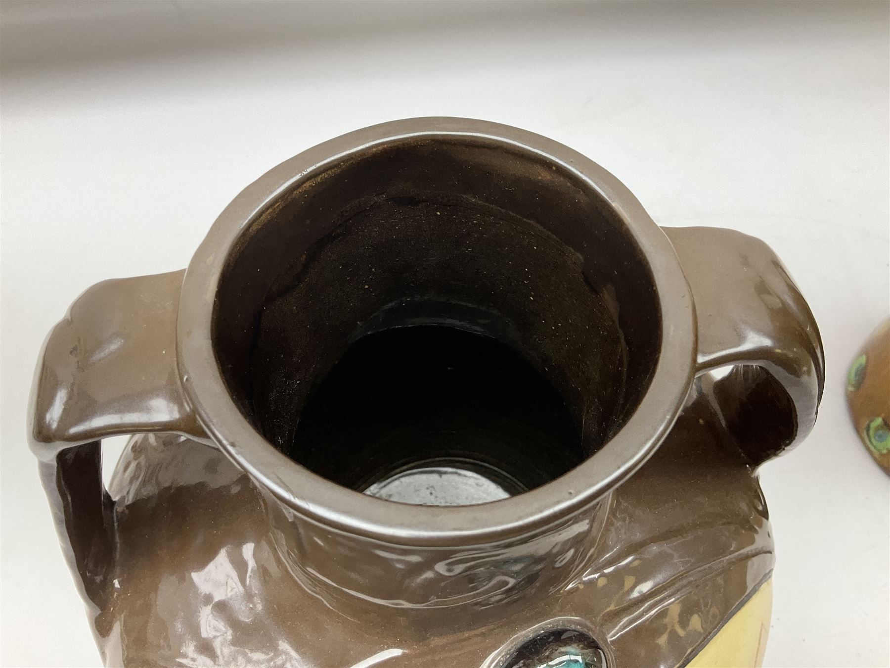 T. Forester Phoenix ware ewer of tapering form decorated with peacock and Bretby twin handled vase decorated with figures fishing in a boat sea scene