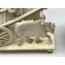 Carved ivory puzzle ball, 19th century, with a carved ivory figural stand, together with a carved cart pulled by a pair of oxen on carved ivory stand