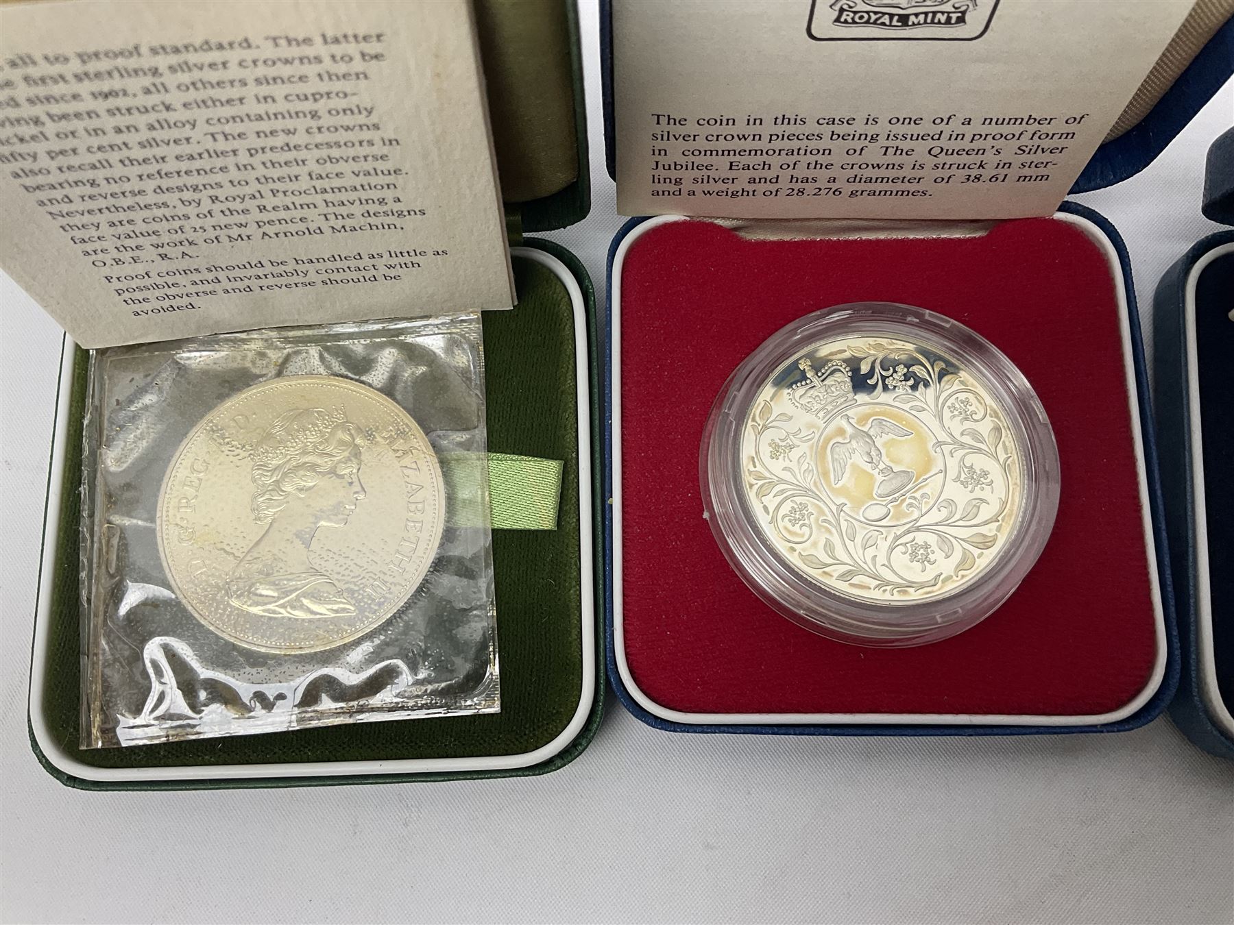 Seven The Royal Mint United Kingdom sterling silver proof crown coins, comprising two 1972, three 1977, 1981 and 1993, all cased with certificates and a Queen Elizabeth II 2001 one ounce fine silver Britannia coin on card (8)