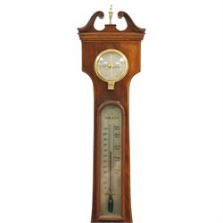 Late 18th century mahogany wheel barometer, swan neck pediment over silvered hygrometer dial and convex mirror, the large silvered register signed by York maker, with spirit level below, the case with boxwood stringing and brass bezels