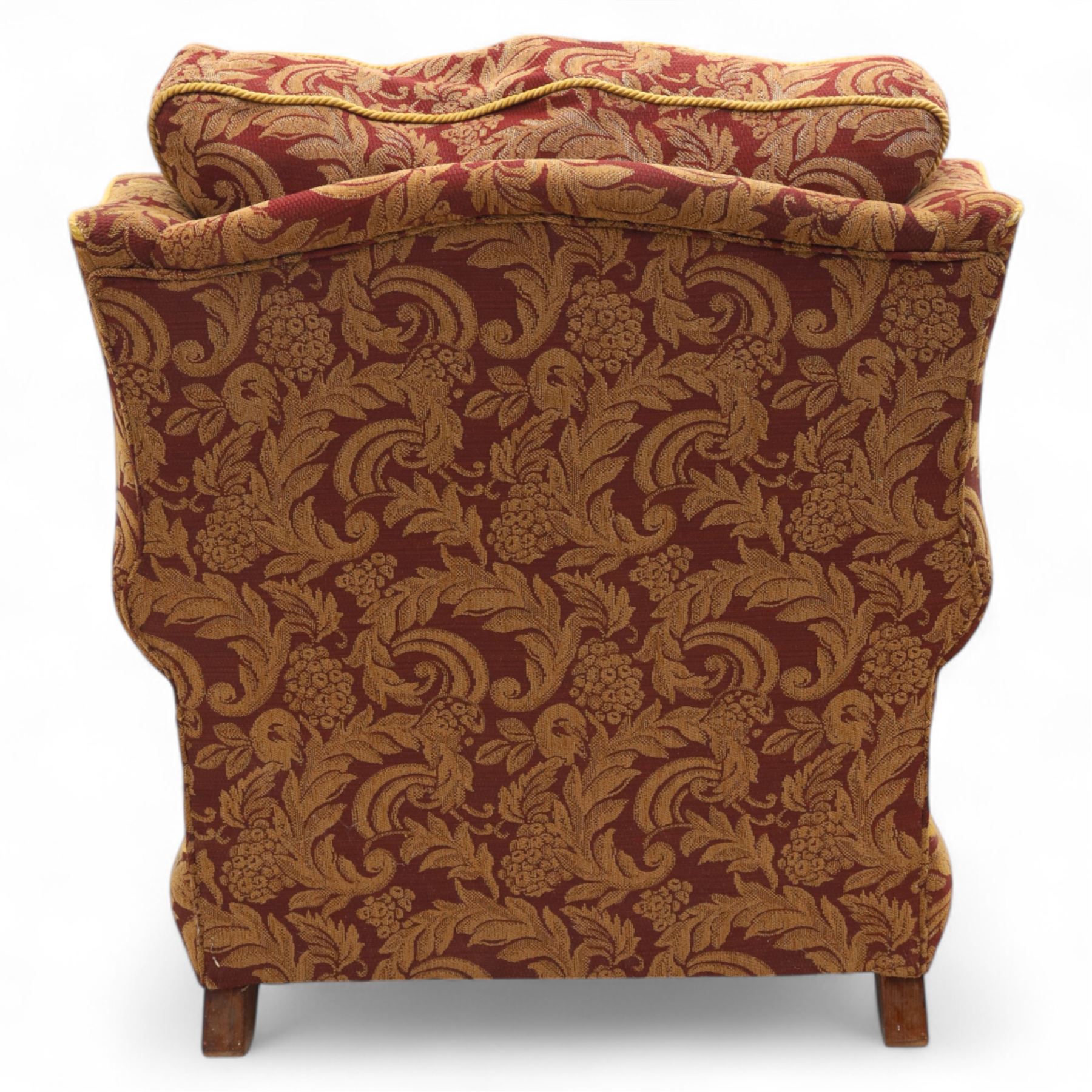 Duresta – pair of armchairs, upholstered in red and gold damask fabric with piped edges, scroll arms and loose feather-filled cushions, raised on turned wooden feet with brass castors
