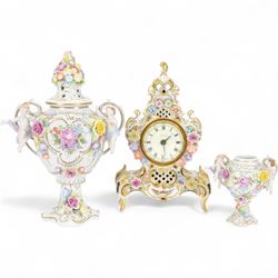 Reine Handarbeit, German ceramic cased mantle clock with applied floral decoration, togeth...