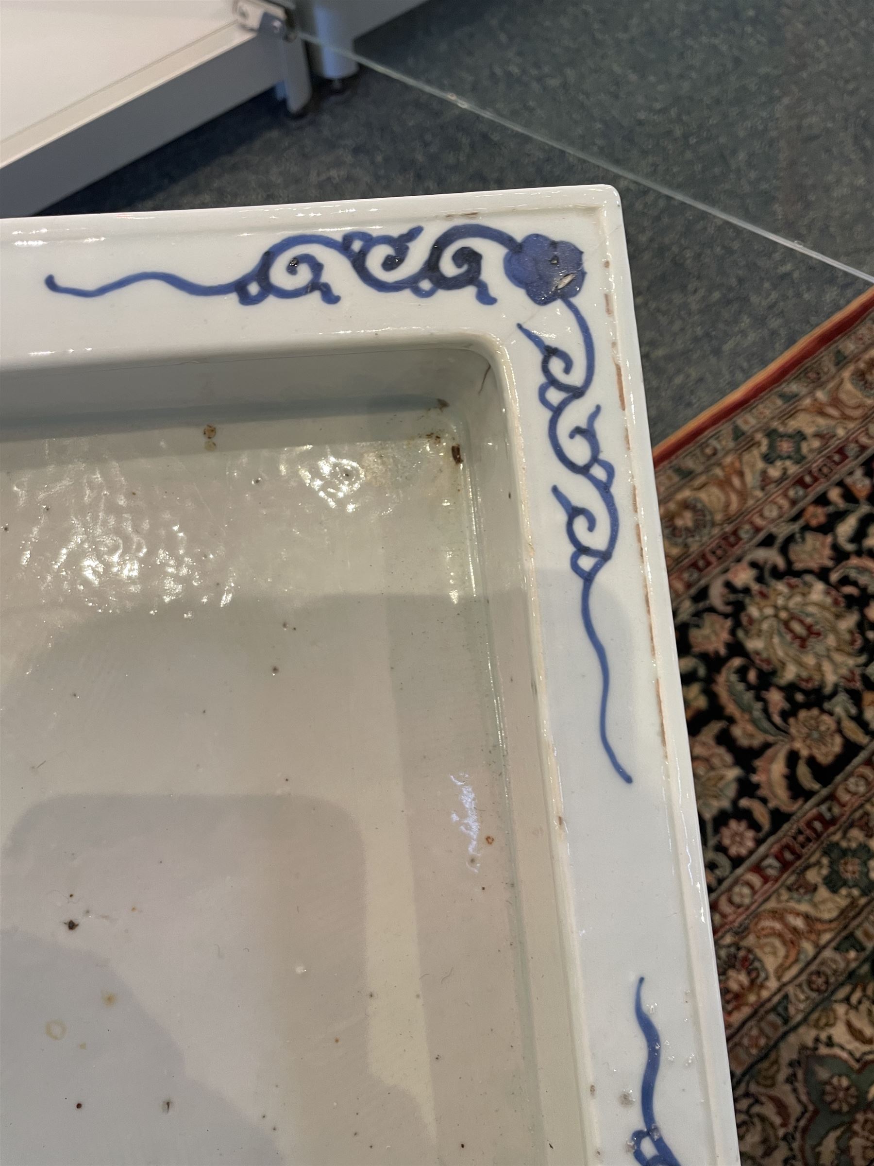 Chinese blue and white planter and stand, each of square slightly tapering and flared form, the planter decorated with two dragons and blossoming peonies, between stylised borders, the stand decorated with flower heads and vines, planter H30cm W29cm, stand H7cm D28.5cm