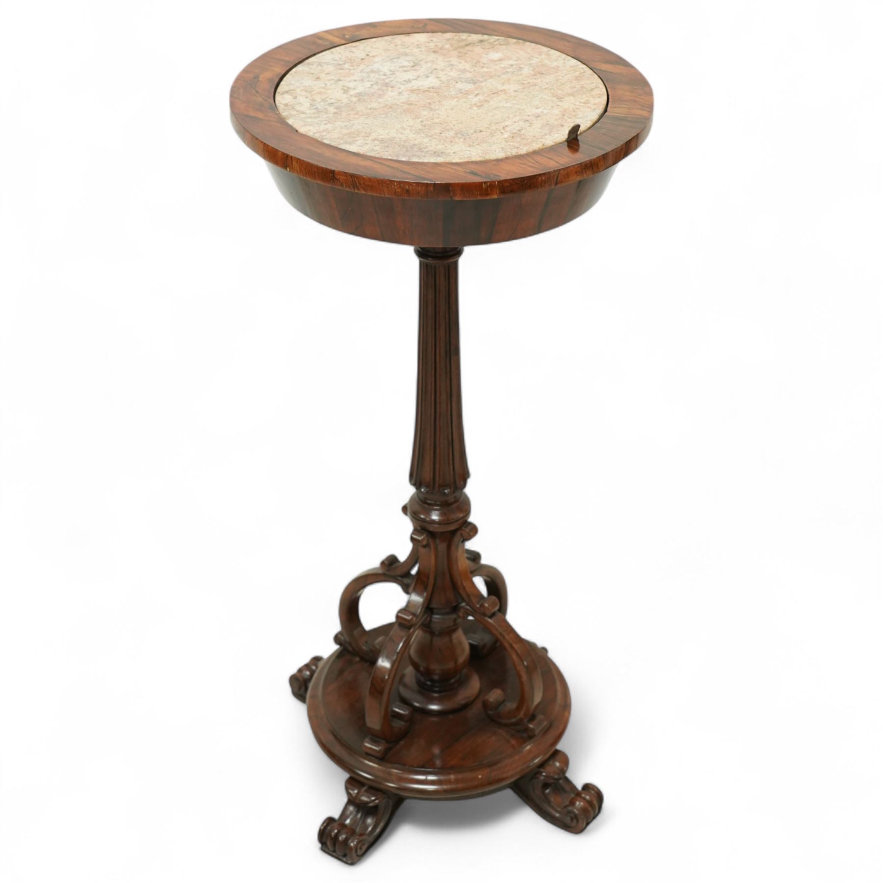 An early Victorian rosewood plant stand with removable marble top, with metal interior liner, circular top above fluted column with arched scroll supports on turned base with scroll feet 