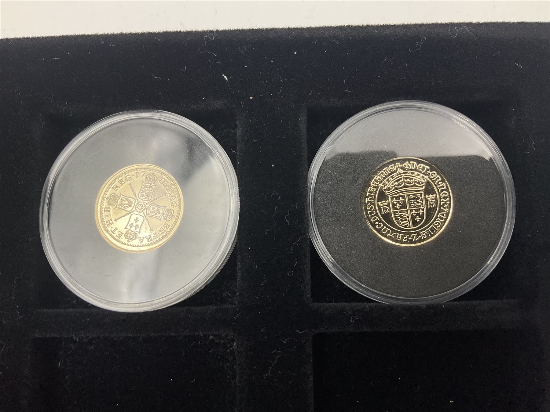 Sixteen hallmarked 9ct gold replica coins from 'The Historic Coins Of Great Britain Museum Gold Collection', housed in a Westminster display case, overall weight approximately 51.3 grams