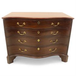 George III mahogany serpentine chest, moulded top over four cock-beaded drawers, the top drawer fitted with baize lined slide opening to reveal divisions,  enclosed by canted and fluted upright corners, the drawer fronts fitted with brass swan neck handles and circular plates with oval escutcheons, lower moulded edge over bracket feet, on lignum vitae castors