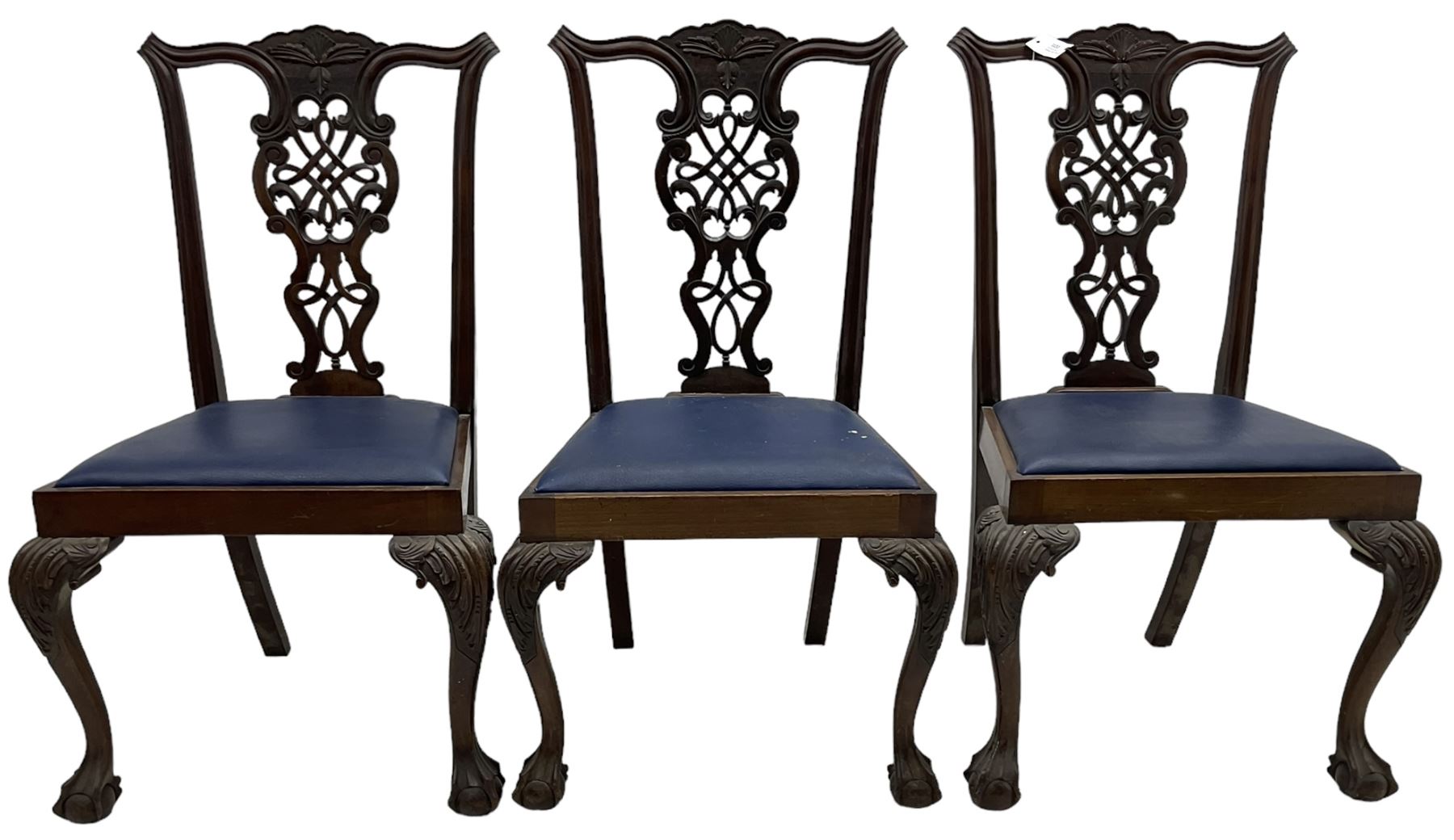 Set of six (5+1) Chippendale design mahogany dining chairs, shaped cresting rail over pierced splat with elaborately carved foliate and scrolling decoration, over drop-in upholstered seats, raised on cabriole supports with scrolled acanthus carved knees and ball and claw carved terminals