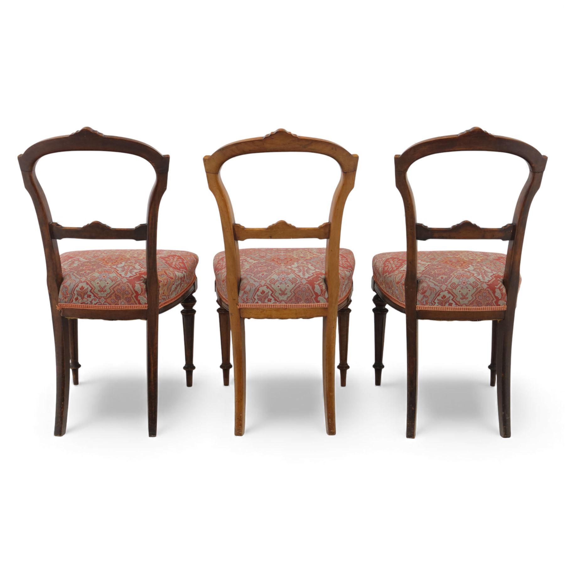 Set of six late Victorian mahogany dining chairs, the shaped top rails carved with anthemion motifs, above pierced splats, floral and geometric fabric seat, on turned and fluted front legs