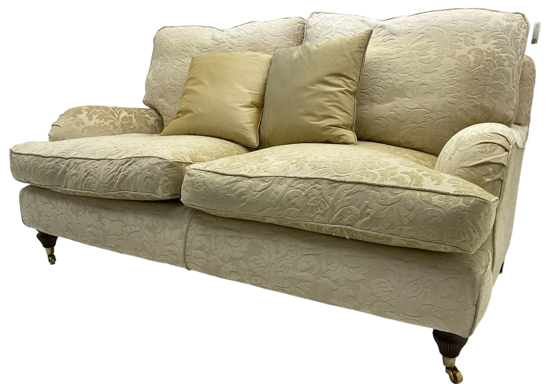 Multi-York - Howard shape two-seat sofa, upholstered in scrolling floral pattern loose covers, rolled arms, on turned front feet with brass cups and castors