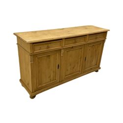 Georgian style pine dresser base, the rectangular top over three drawers and three cupboards, fluted uprights with foliate carved brackets