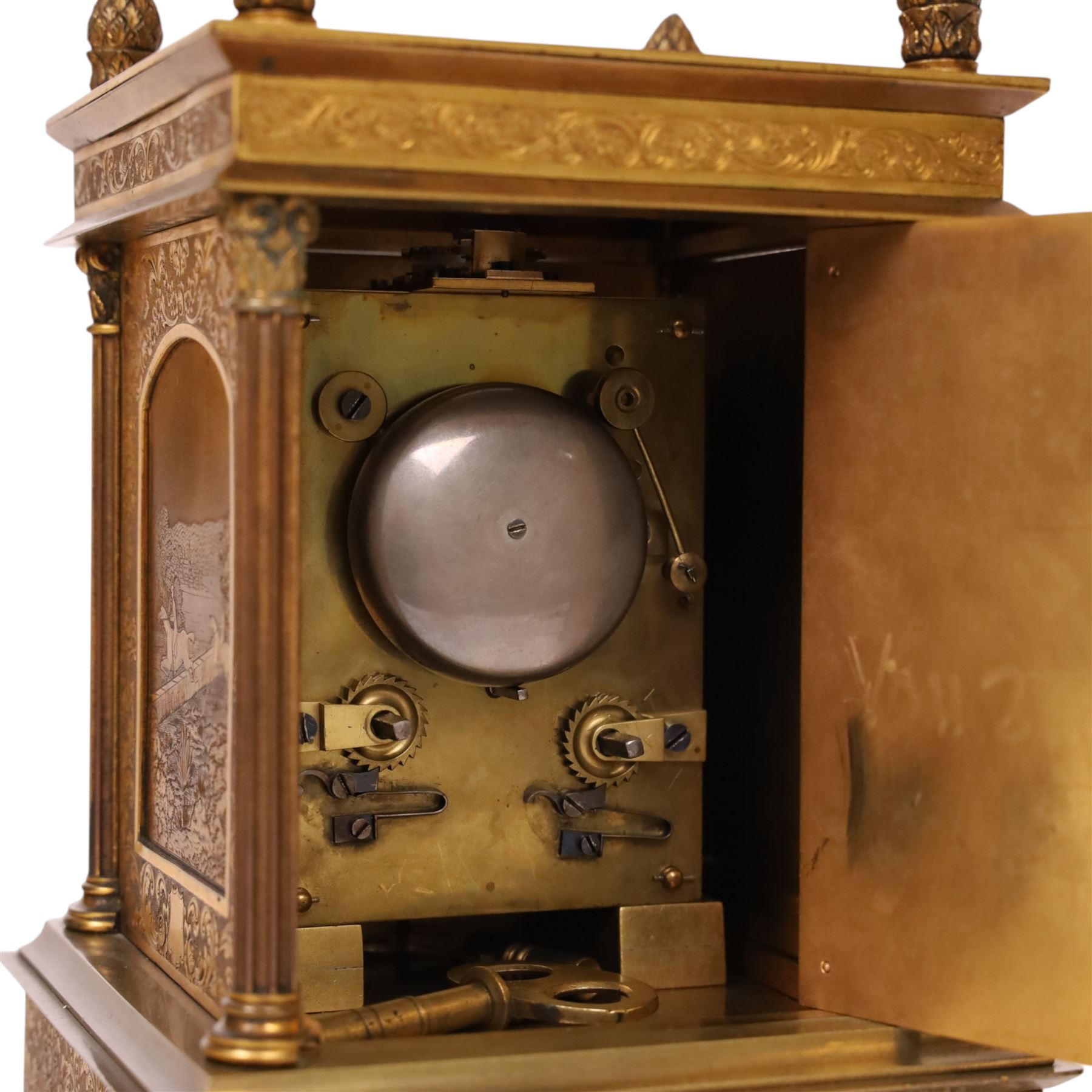 Early 20th century brass mantle clock, the face and case profusely engraved with floral scrolls, the sides inset with hunting scene panels, flanked by four Corinthian columns with acorn finials, striking the hours and halves on bell, H20.5cm W13cm