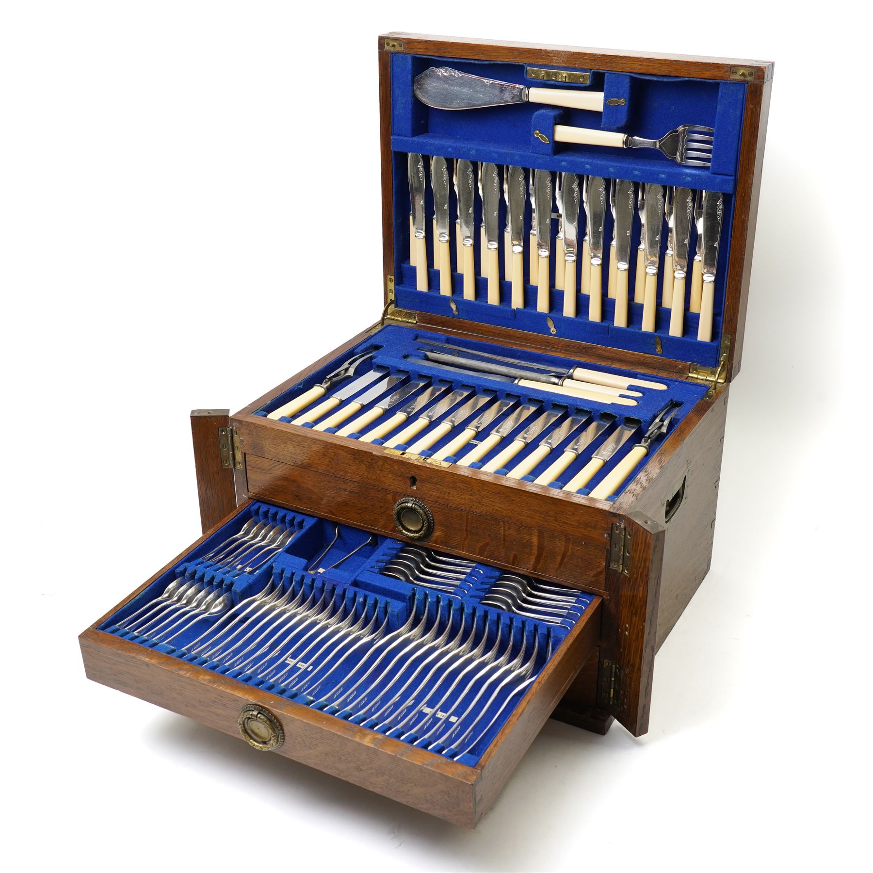 Suite of plated table cutlery for twelve covers including fish cutlery and servers, fruit knives and forks with mother of pearl handles, bone handled knives, carvers etc in an oak  three drawer cabinet with hinged lid W47cm 160 pieces