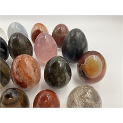 Collection of twenty-one hardstone specimen eggs, including labradorite, calcite, orbicular jasper, tiger's eye, smokey quartz, fossilised wood etc, originally part of the collection of the late Stanley J Seeger