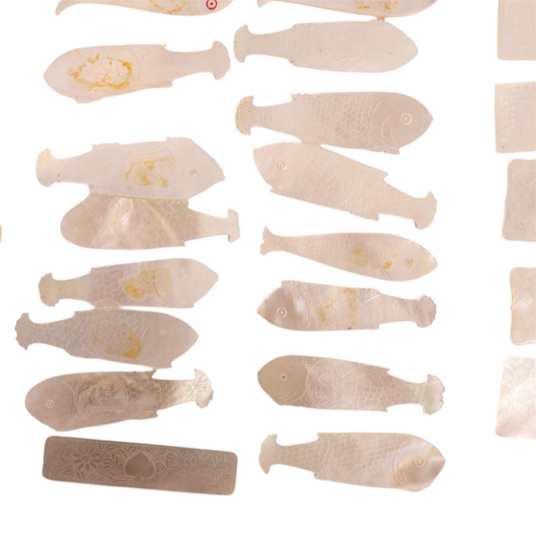 Collection of approximately sixty mother-of-pearl gaming tokens, including fish-shaped, rectangular, circular examples 