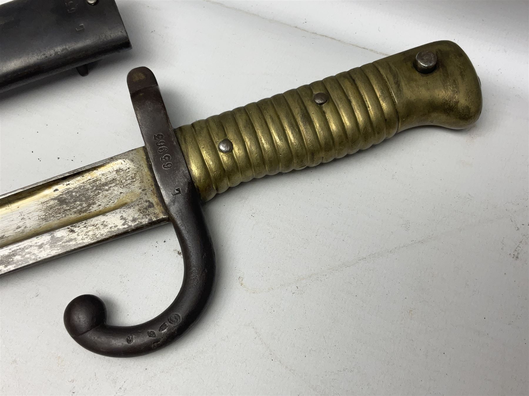 French Model 1866 Chassepot bayonet with 57cm curving fullered steel blade dated 1873 No.L63963; in steel scabbard with conforming number L71.5cm overall; and French St. Etienne Gras bayonet dated 1878 No.K10674 in steel scabbard numbered 79437 (2)
