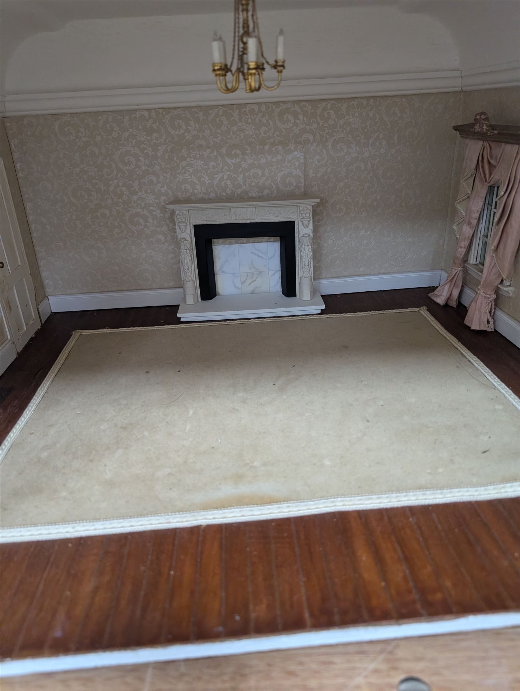 Two modern three storey dolls houses, each painted green with decorated interiors, both upon a single white wooden base, together with a large collection of dolls house furniture, accessories and figures 