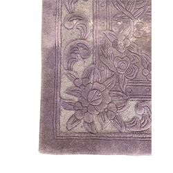 Chinese wool rug, purple ground with tonal floral and foliate pattern, central medallion of stylised flowers, the corners with large rosettes, framed by broad border of scrolling floral and leafy motifs 