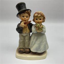 Four Hummel figures by Goebel, comprising Wedding, The Love Lives on, Valentine Joy and Valentine Gift, together with a stand for the valentine figures, largest H18cm