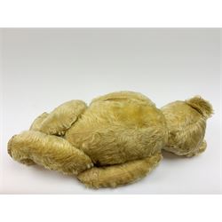 Chad Valley large teddy bear c1930s with wood wool filled blond mohair body, jointed swivel head with glass eyes, shaved muzzle with vertically stitched nose and mouth and jointed limbs H21
