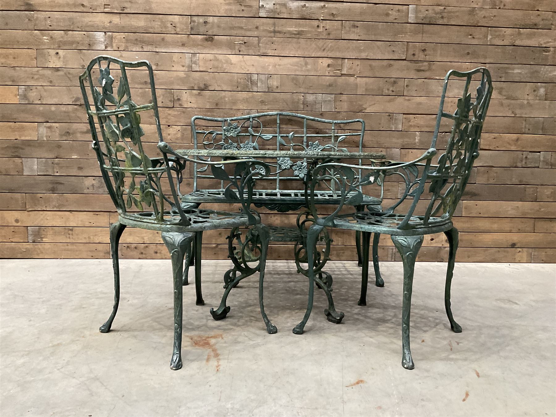 Cast aluminium garden dining set, comprising ornate circular table (D91cm, H68cm) a two seater bench, on cabriole supports (W118cm, H93cm, D55cm), and two matching armchairs (W55cm, H95cm, D54cm)