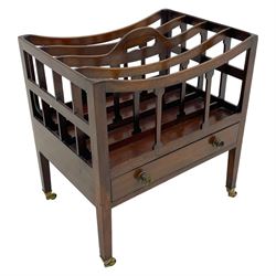  Georgian design mahogany Canterbury, four divisions with dished upper rails, the central rail pierced with handle, fitted with single drawer, on square supports with brass cups and castors 