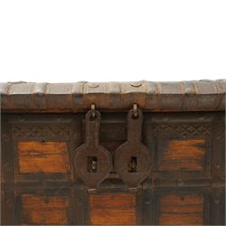 Large 19th century North Indian teak and wrought iron-bound dowry chest, probably Rajasthani, the shallow domed plank lid secured with broad iron straps above a lattice-carved frieze and grid of riveted iron bands, with twin shaped hasps, side carrying handles and fitted interior till, on bracket feet