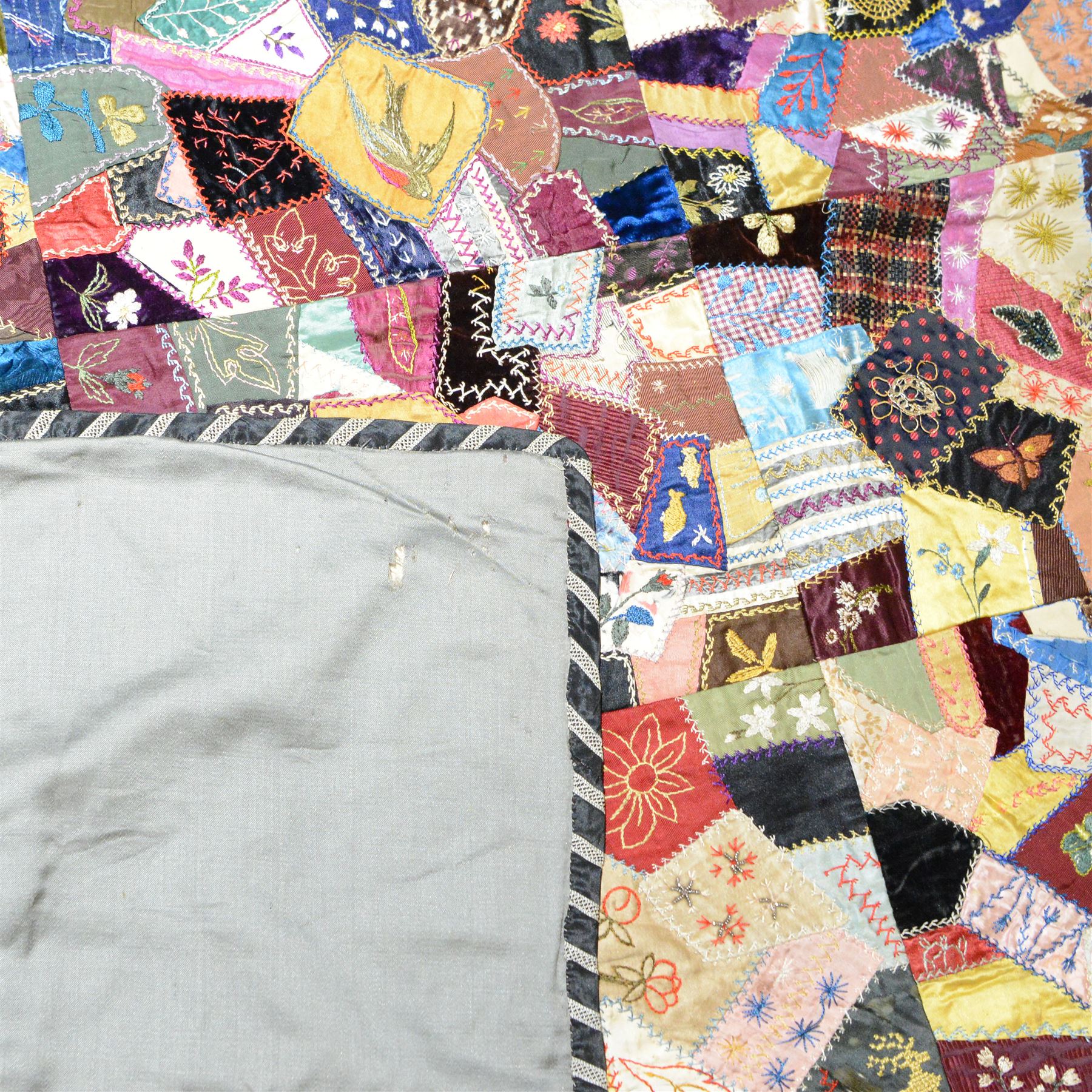 Victorian crazy pattern patchwork quilt, of irregular scraps, within a silk and lace border, L174cm, W134cm
