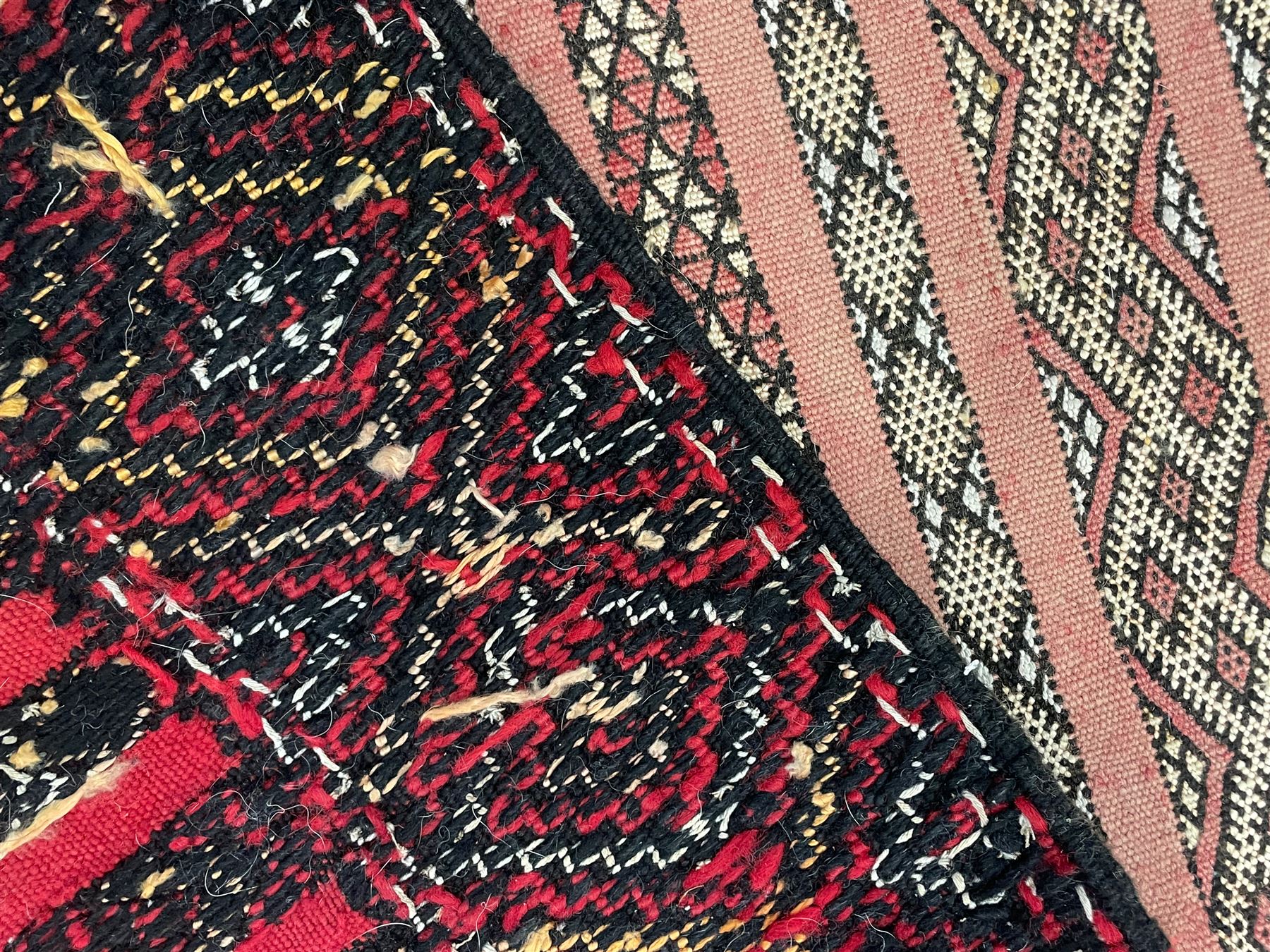 Moroccan Berber rug, pale red ground, decorated with horizontal geometric pattern bands, lozenge pattern upright bands