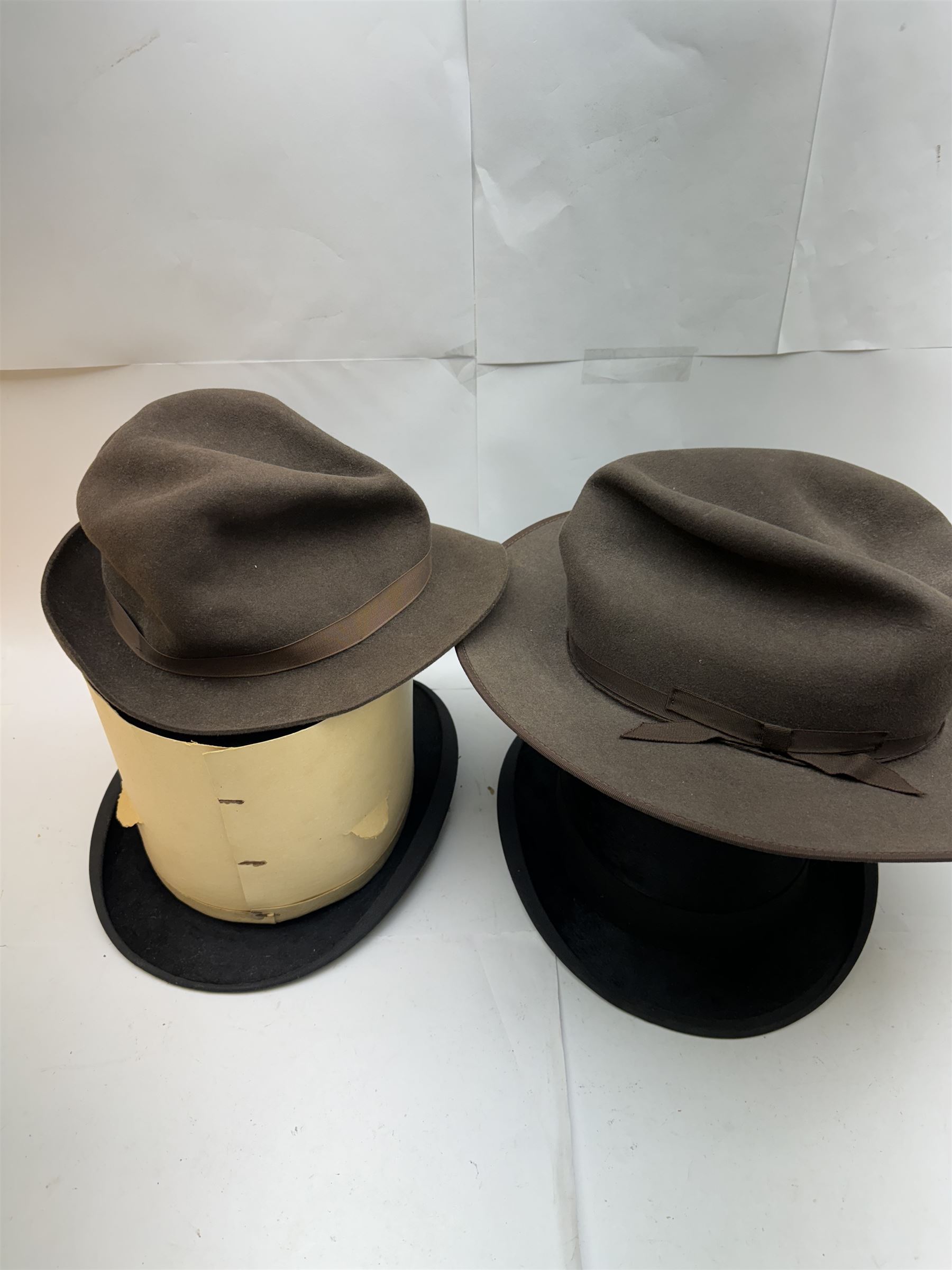 Akubra pure fur felt trilby hat, together with another trilby and two top hats, one by Woodrow and one by Dunn & Co