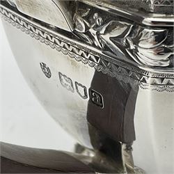 Victorian silver four piece tea service, comprising teapot, teapot stand, twin handled open sucrier and milk jug, each of octagonal form with foliate bud border and engraved decoration including crest to canted panels, and vacant panels, the teapot with ivory finial to the hinged cover and later wooden handle, hallmarked Edward Barnard & Sons Ltd, London1896, teapot including finial H15cm, milk jug including handle H16cm, teapot stand W11.5cm

This item has been registered for sale under Section 10 of the APHA Ivory Act