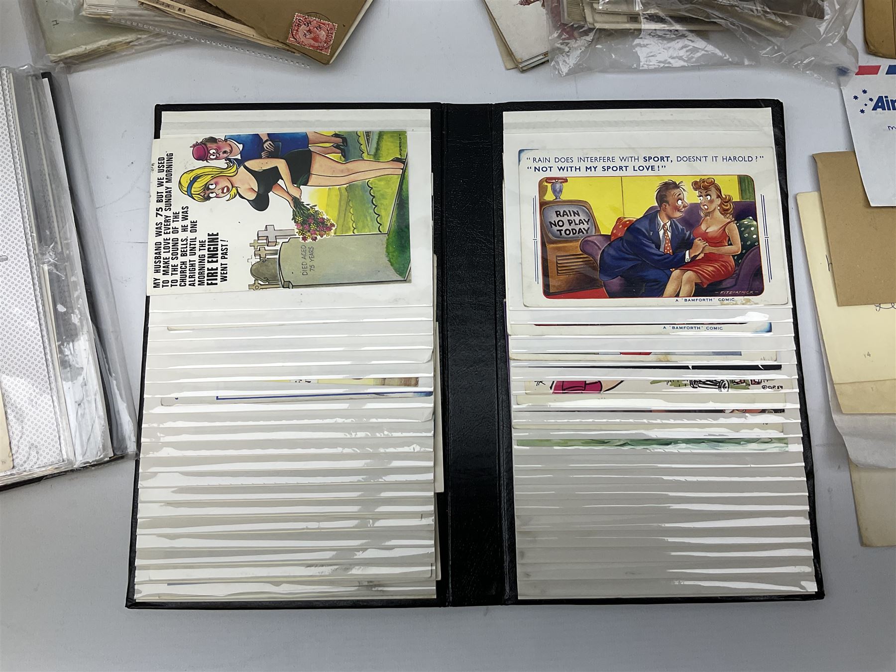 Comic postcards including Bamforth and Quip examples together with WW1 postcards, a collection of world stamps including examples from China, and other ephemera 