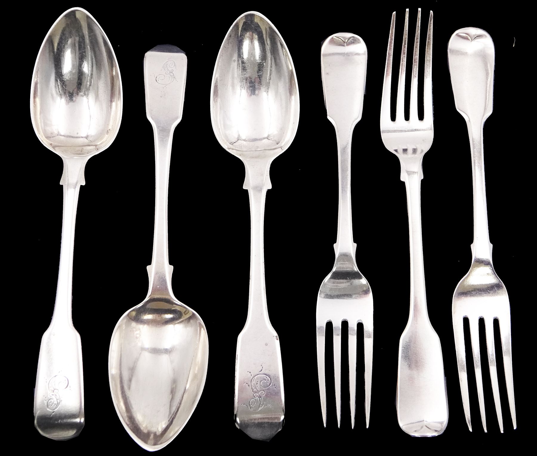 Three George IV silver fiddle pattern dessert spoons, with engraved initial to terminal, hallmarked William Bateman I, London 1820, together with three William IV silver fiddle pattern forks, with engraved initial verso, two hallmarked London 1831, maker's mark R.H probably Robert Hennell II, and one hallmarked Jonathan Hayne, London 1836