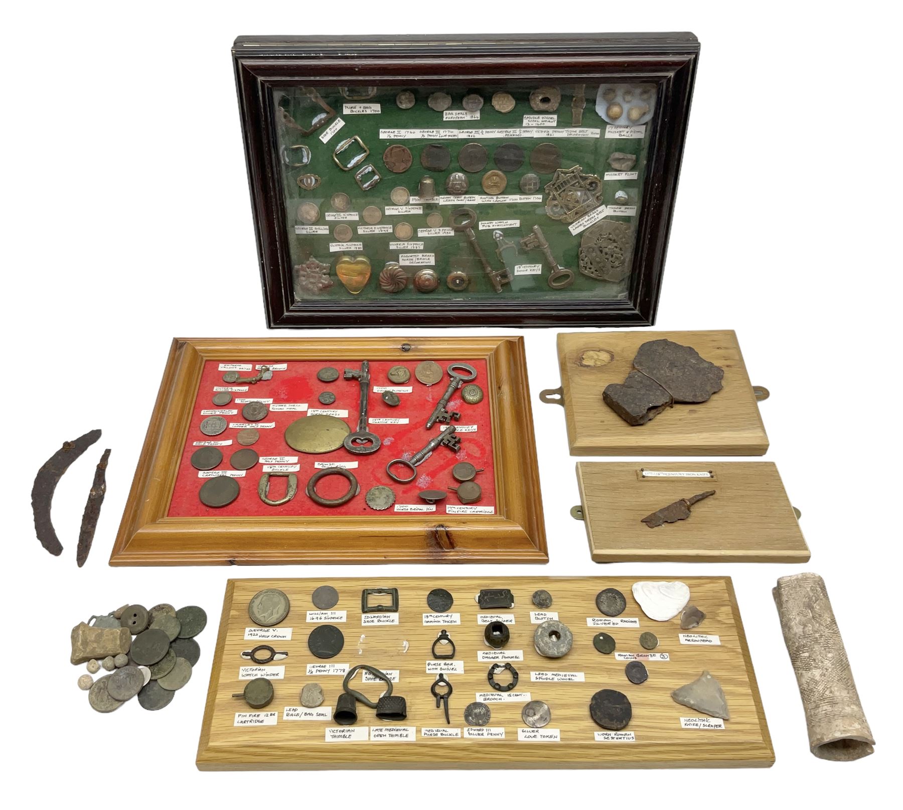 Collection of metal detecting finds and antiquities, housed on five display boards and some loose, to include coins, keys, axe head etc 