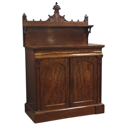  Victorian mahogany Gothic Revival chiffonier, raised shelf back with shaped cresting on pierced scroll supports, base with concealed frieze drawer above a pair of matched veneer panel doors enclosed by pilasters, interior with shelves on a skirted base, W108cm H166cm, D55cm    