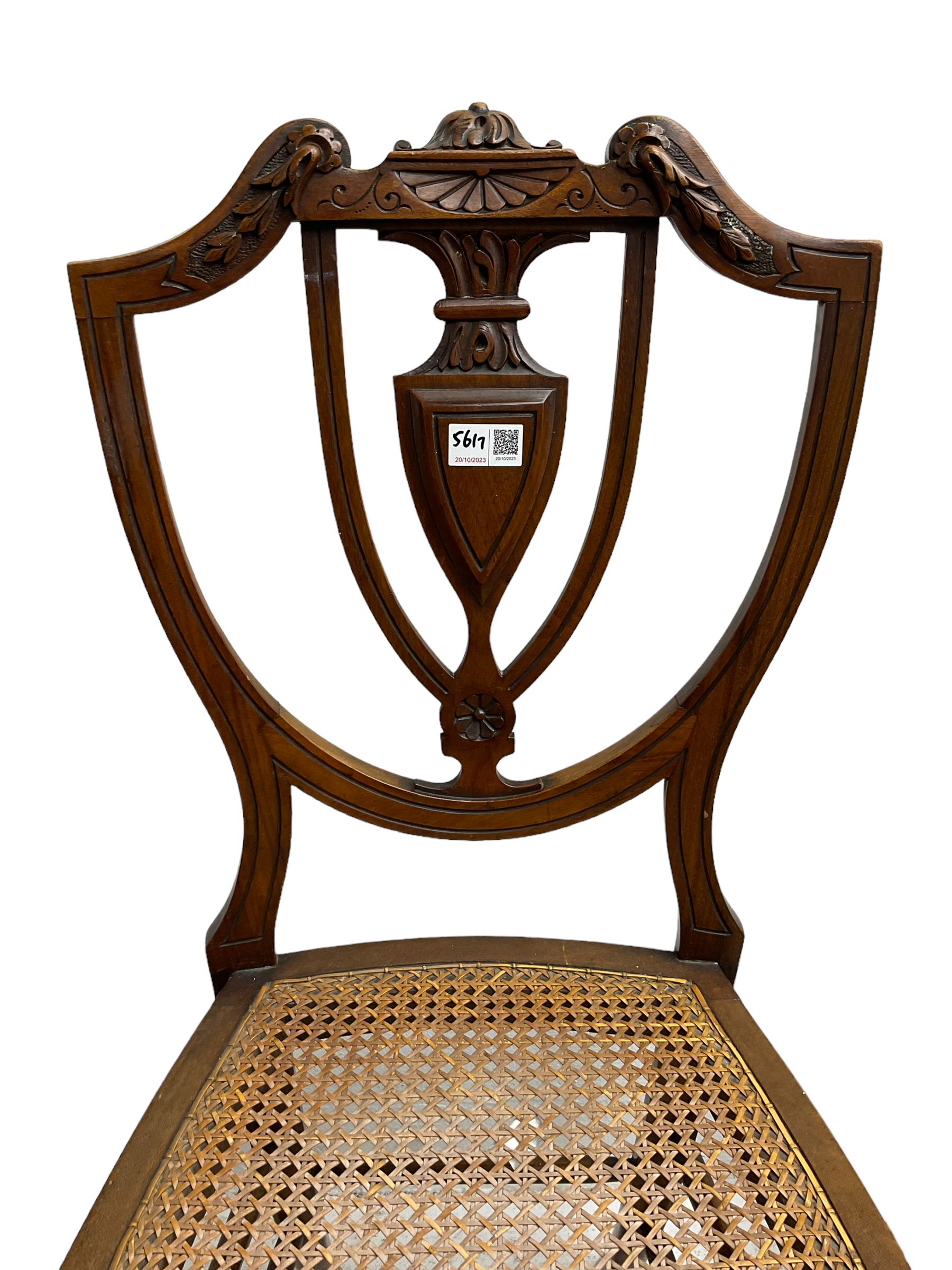 Pair of Regency rosewood framed side chairs, carved back rails over cane seat, raised on reeded supports (W46cm D50cm H84cm); set of three Edwardian walnut cane seat bedroom chairs, carved shield back (W41cm H88cm)