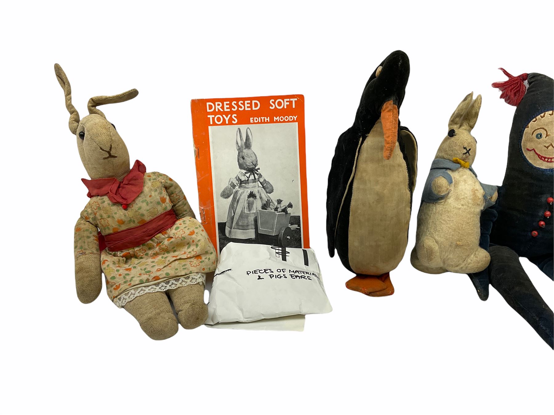 1950's teddy bear with jointed limbs, revolving head, wood filled body, stitched nose and mouth, applied glass eyes and foot pads, together with a quantity of handmade soft toy rabbits and penguins. 