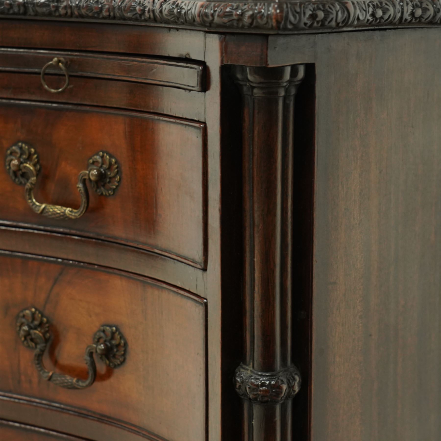 Georgian design mahogany serpentine chest, with rectangular top with floral rosette carved edge, cluster reeded columns with brush slide above four graduated drawers on ogee bracket feet 