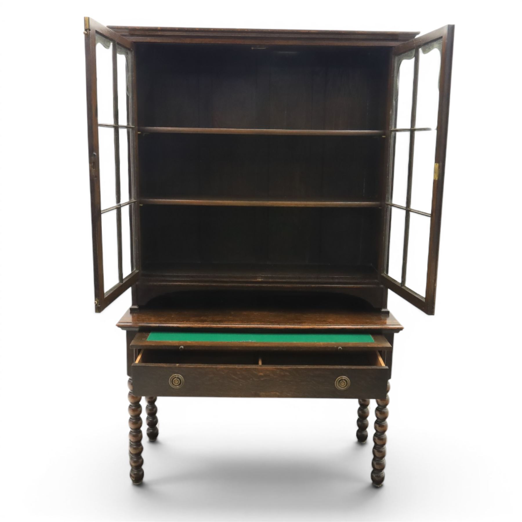 Early 20th century Jacobean Revival dark stained oak dresser, the associated upper section enclosed by twin glazed doors with shaped moulded glazing bars, over separate base fitted with two drawers, raised on bobbin turned legs