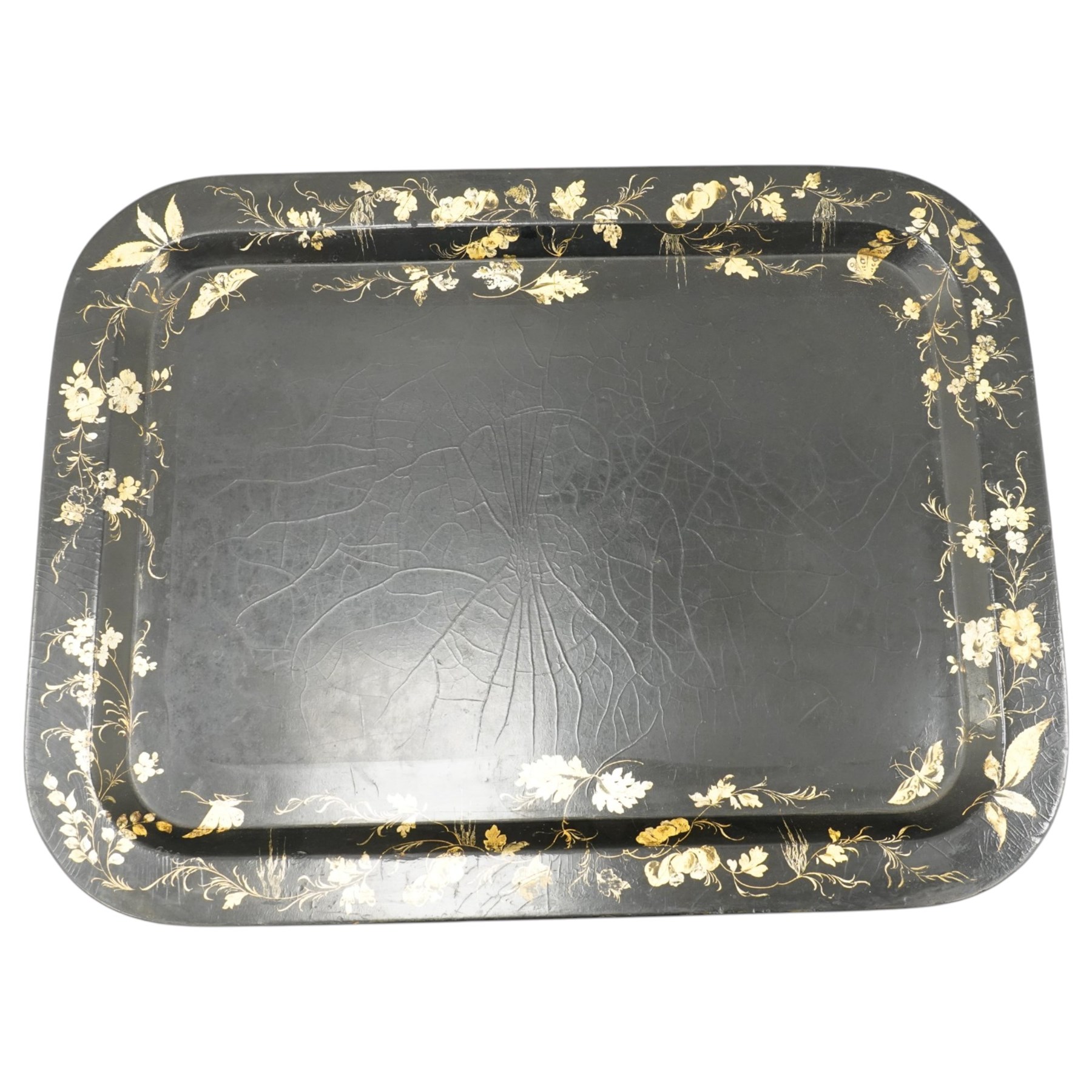 Victorian ebonised and gilt-painted papier-mâché tray on later ebonised and parcel-gilt simulated bamboo stand, the rectangular removable tray with gilt foliate and butterfly scenes with scrolling branches, the base on four ring-turned and splayed supports united by X-stretcher