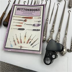 Collection of buttonhooks, shoe horns and manicure items, twenty-three with silver handles, two stamped 800 and others hallmarked, Buttonhooks: A Guide For the Collector' by Jackie Booker and sixteen hatpins