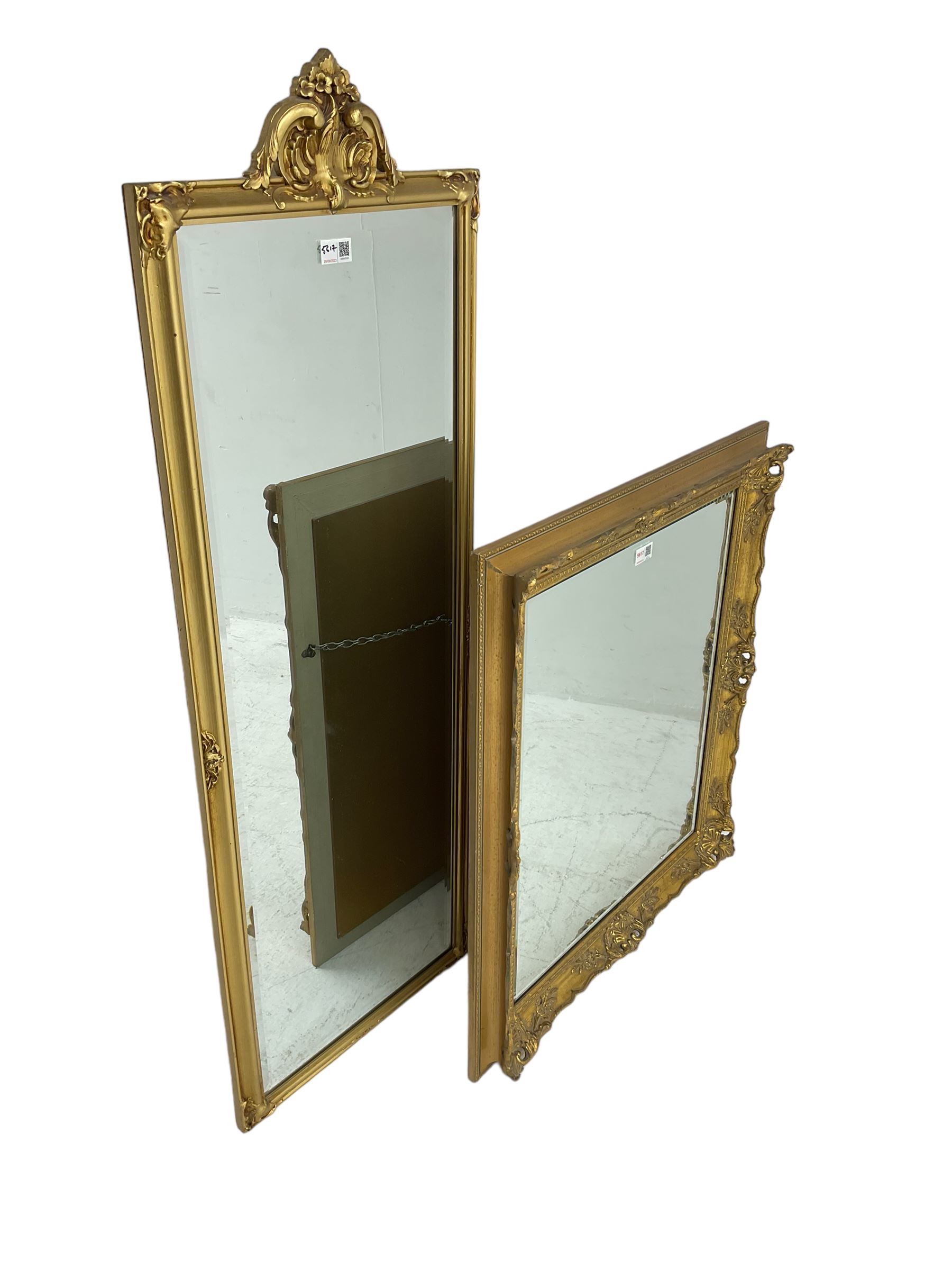 Rectangular gilt framed wall mirror with scrolled foliate cartouche (42cm x 118cm); and a swept gilt framed rectangular wall mirror (65cm x 75cm)