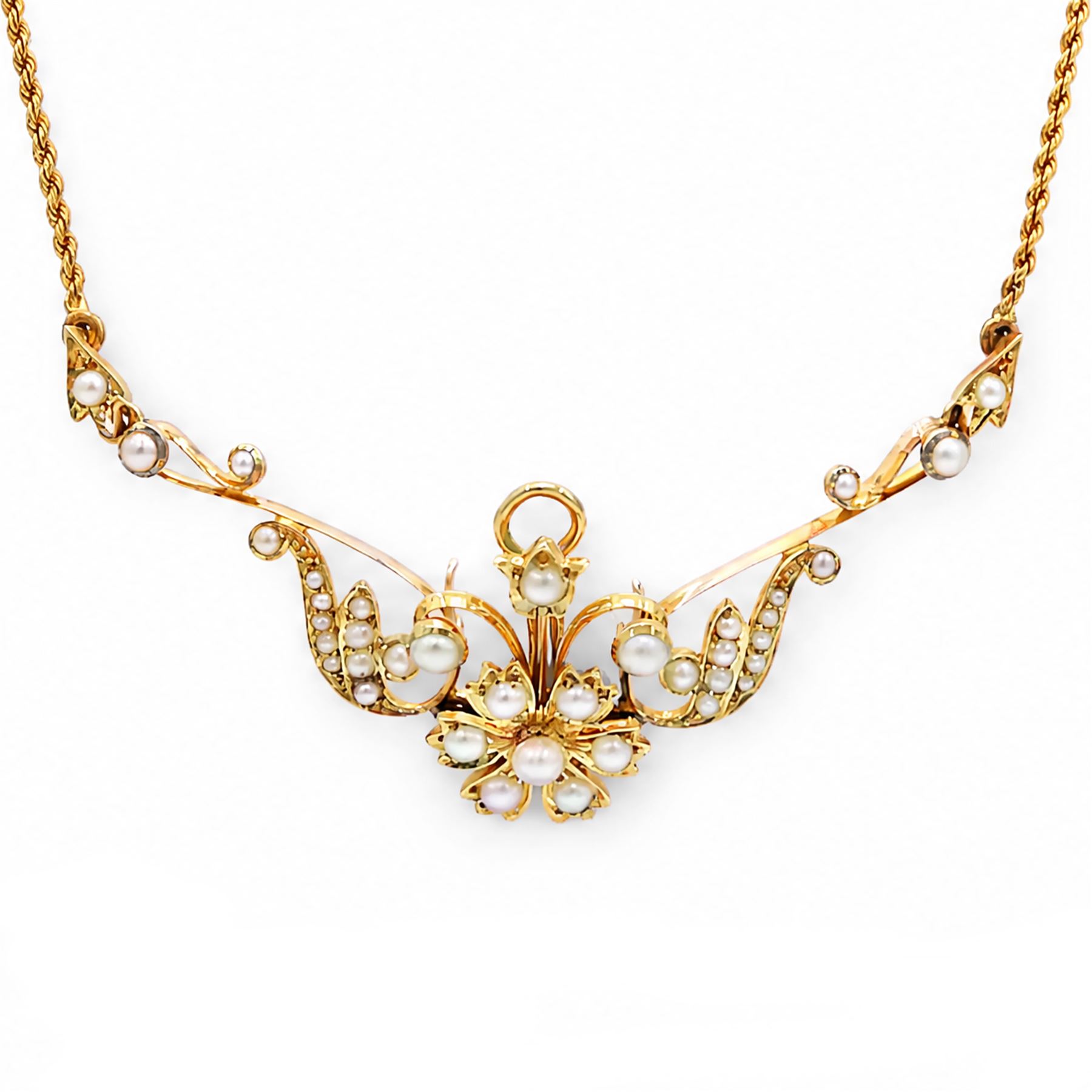 Edwardian gold pearl floral necklace, the openwork stylised floral and scroll mount set with split and seed pearls, to a rope twist chain necklace, in a tooled leather and blue velvet box