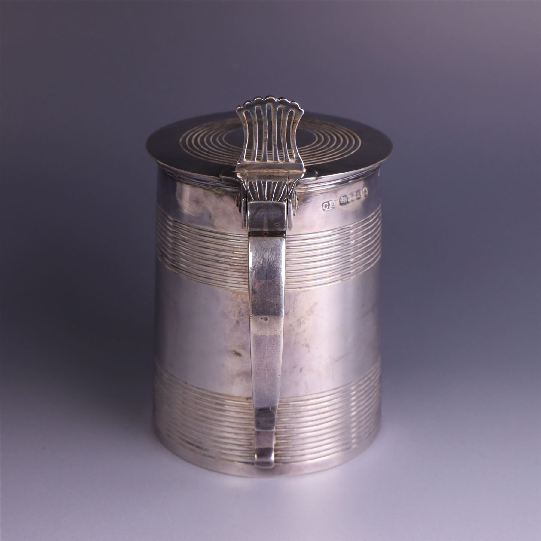 George III silver lidded tankard, with two ribbed bands to the cylindrical body, the hinged lid with concentric circle to cover and pierced thumbpiece, hallmarked Charles Fox I, London 1816, including thumb piece H16cm