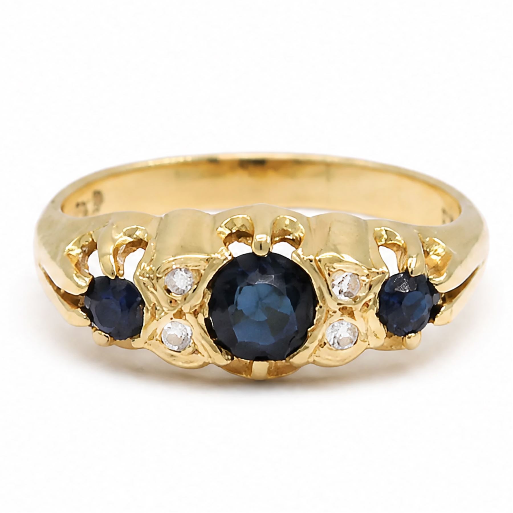Gold sapphire and diamond ring, three round cut sapphires spaced by four single cut diamond accents, stamped 18ct