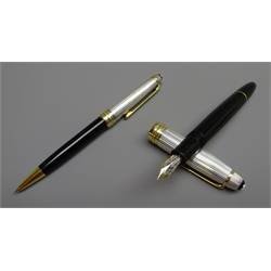  Writing Instruments - Montblanc Meisterstuck set of two fountain pen with '18k' gold nib and propelling pencil, both with sterling silver tops, cased, with warranty/service guides (2)   